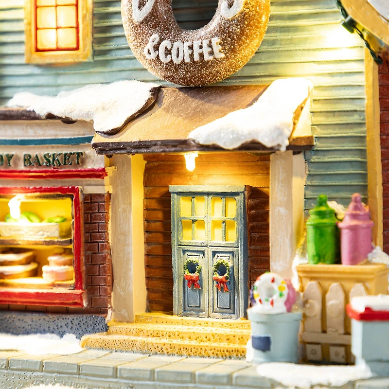 Glitzhome® 10.25" Lighted Christmas Donuts & Coffee Shop Resin Village with Movement and Music