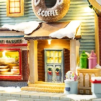 Glitzhome® 10.25" Lighted Christmas Donuts & Coffee Shop Resin Village with Movement and Music
