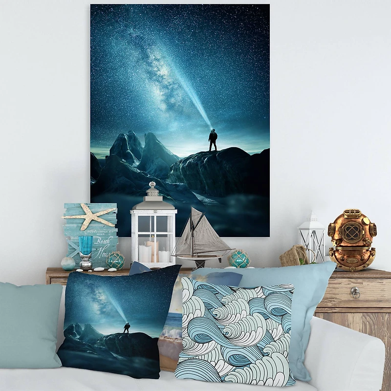 Designart - A Man Shining A Light Into The Night Sky