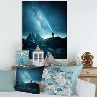 Designart - A Man Shining A Light Into The Night Sky