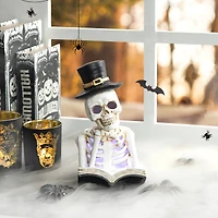 Glitzhome® 10" Lighted Halloween Resin Skull Reading Book Table Décor