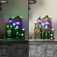 Glitzhome® 11"H Lighted Resin Halloween Haunted House Village
