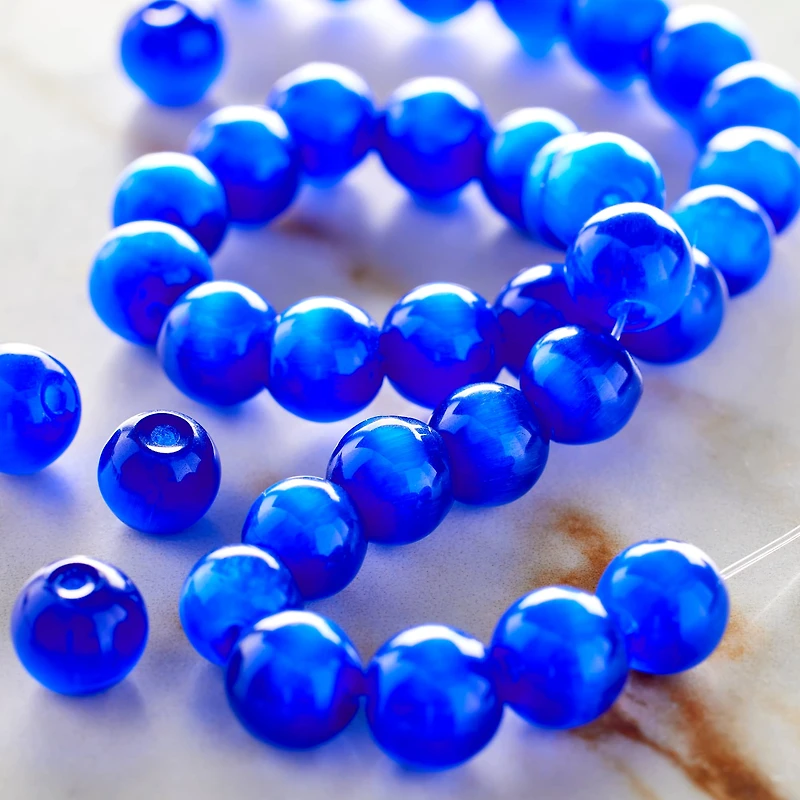 12 Packs: 34 ct. (408 total) Cobalt Blue Cat's Eye Glass Round Beads, 8mm by Bead Landing™