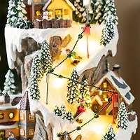 Glitzhome® 15.5" Lighted Christmas Skiing Moutain Resin Village with Movement and Music