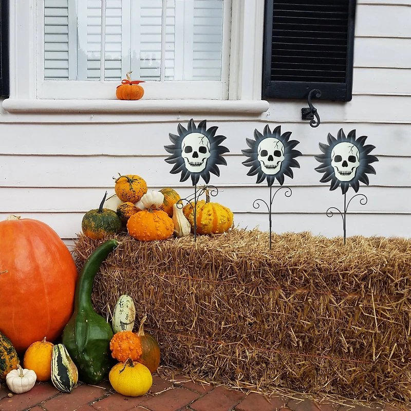 Glitzhome® 24" Halloween Metal Sunflower Skulls Glow-in-Dark Yard Stakes, 3ct.