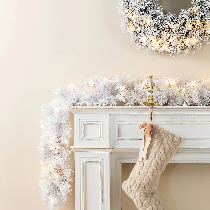 Glitzhome® 6ft Pre-Lit Snow Flocked White Pine Christmas Garland with Timer, 2ct.