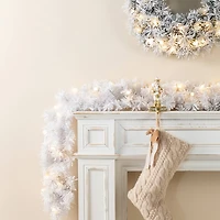 Glitzhome® 6ft Pre-Lit Snow Flocked White Pine Christmas Garland with Timer, 2ct.