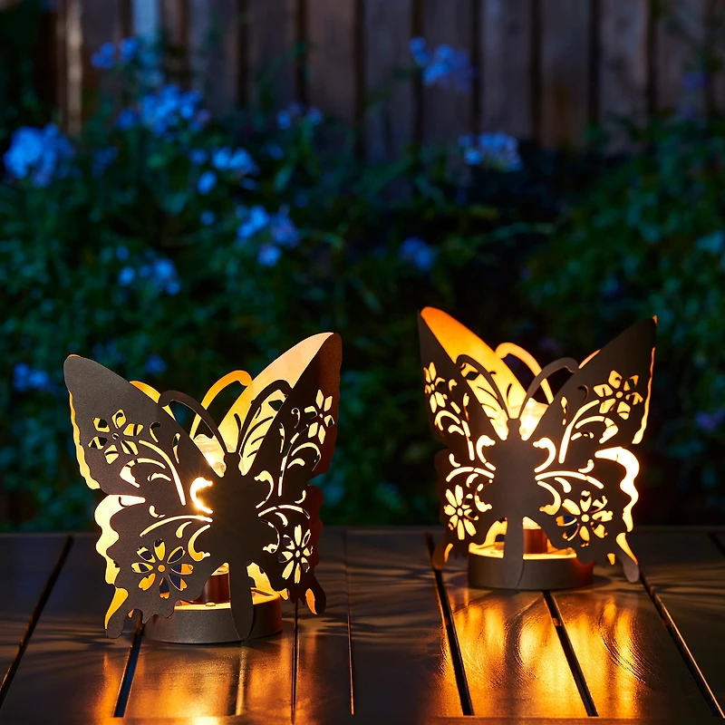 Glitzhome® 9" Metal Flying Butterfly Silhouette Solar Powdered Edison Bulb Outdoor Lanterns, 2ct.