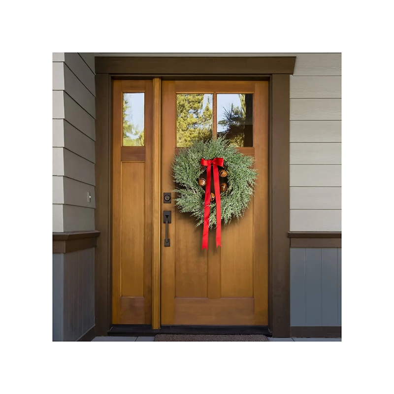 Hello Honey® 24" Round Mixed Pine Wreath with Red Ribbon & Rust Finish Metal Bells