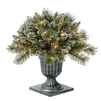 24" Glittery Bristle® Pine Porch Bush in Dark Bronze Plastic Urn with White Tipped Cones