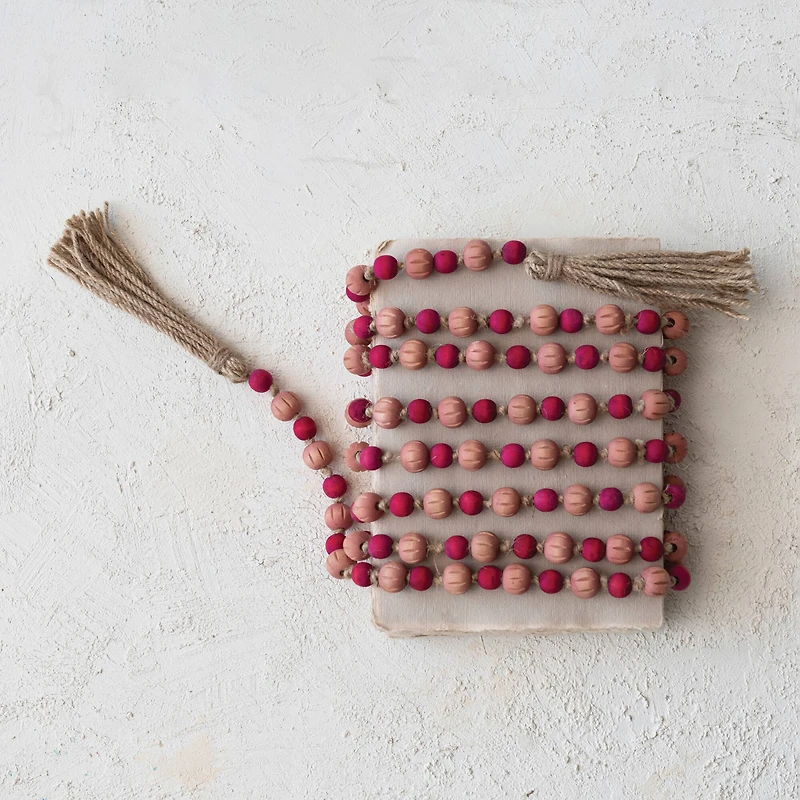 Hello Honey® 12ft. Pink & Red Paulownia Wood Beads with Jute Tassels Garland