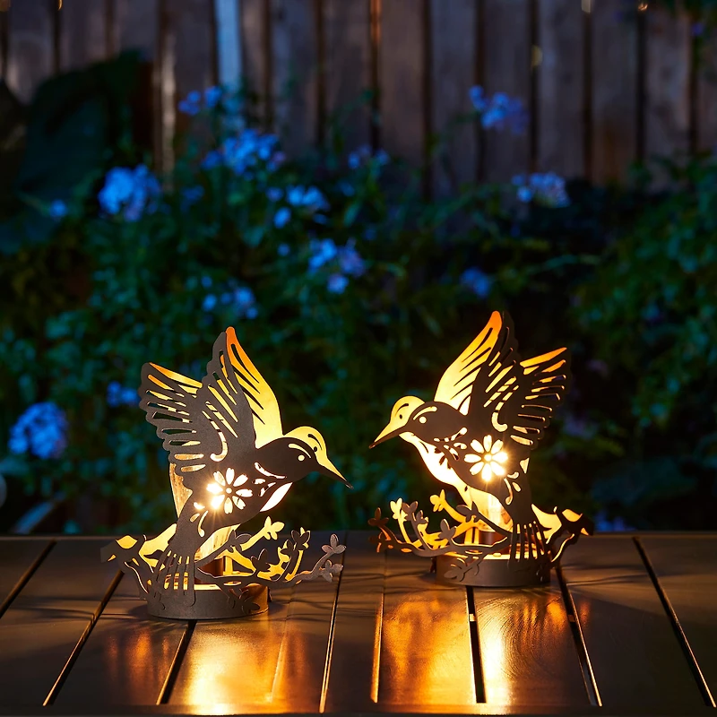 Glitzhome® 9.75" Metal Flying Hummingbird Silhouette Solar Powered Edison Bulb Outdoor Lanterns, 2ct.
