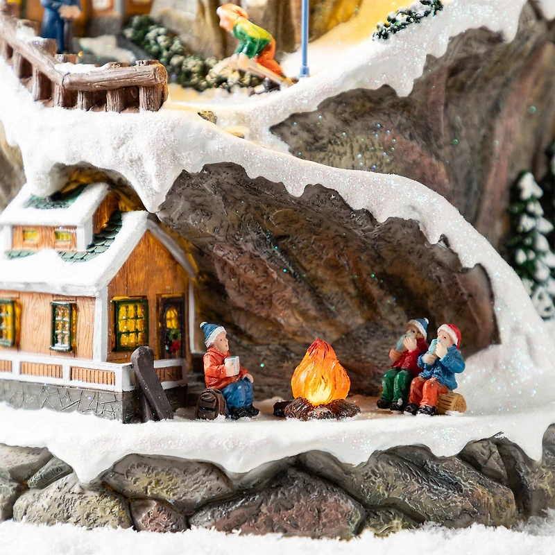 Glitzhome® 15.5" Lighted Christmas Skiing Moutain Resin Village with Movement and Music