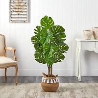 4ft. Monstera Artificial Tree in Boho Chic Handmade Natural Cotton Woven Planter with Tassels UV Resistant (Indoor/Outdoor)