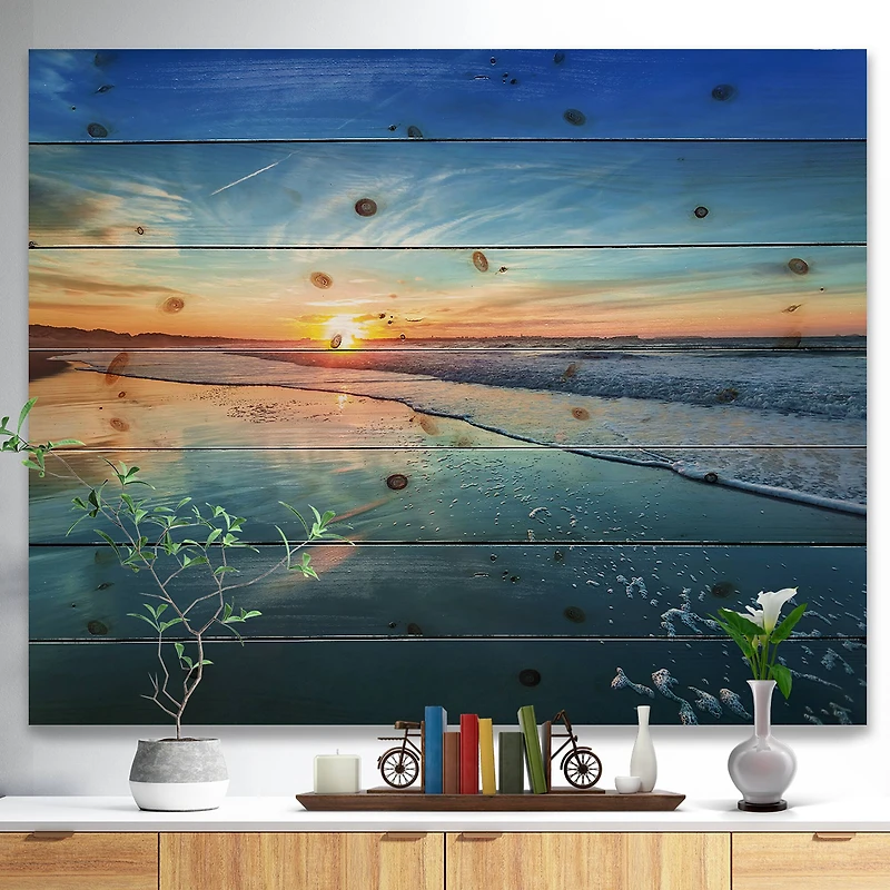 Designart - Blue Seashore with Distant Sunset