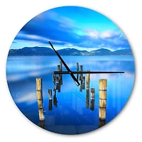Designart 'Wooden Pier Remains In Blue Sea Modern Wall Clock