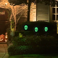 Glitzhome® 24" Halloween Metal Sunflower Skulls Glow-in-Dark Yard Stakes, 3ct.