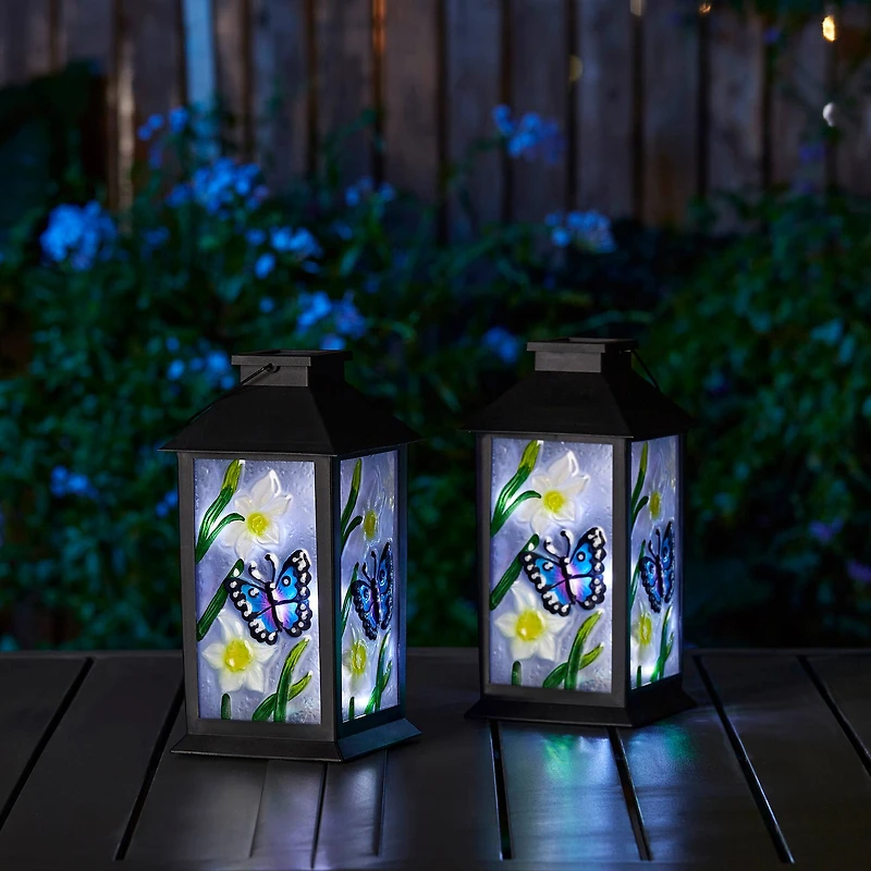 Glitzhome® 11" Glass with Butterfly & Flower Pattern Solar Powered Hanging Lanterns, 2ct.