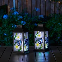 Glitzhome® 11" Glass with Butterfly & Flower Pattern Solar Powered Hanging Lanterns, 2ct.
