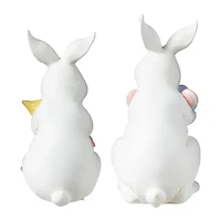 Glitzhome® Set of 2 Easter Resin Bunny Holding Macaron Table Decor