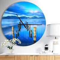 Designart 'Wooden Pier Remains In Blue Sea Modern Wall Clock