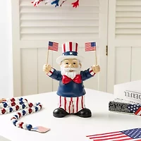Glitzhome 9" Santa Holding Flags
