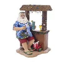 Kurt Adler 11-Inch Fabriché Beach Santa Sitting At Tiki Bar