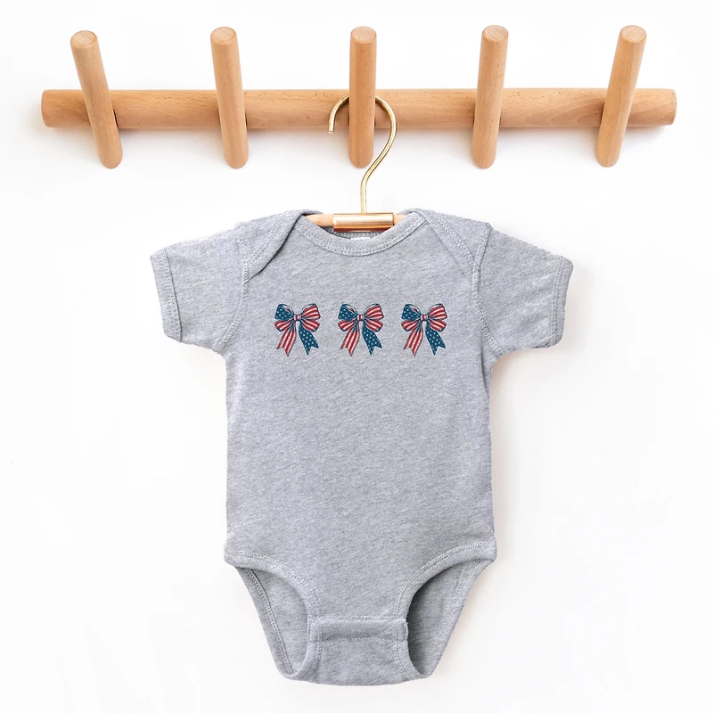 The Juniper Shop - Patriotic Bows Row Baby Short Sleeve Graphic Bodysuit