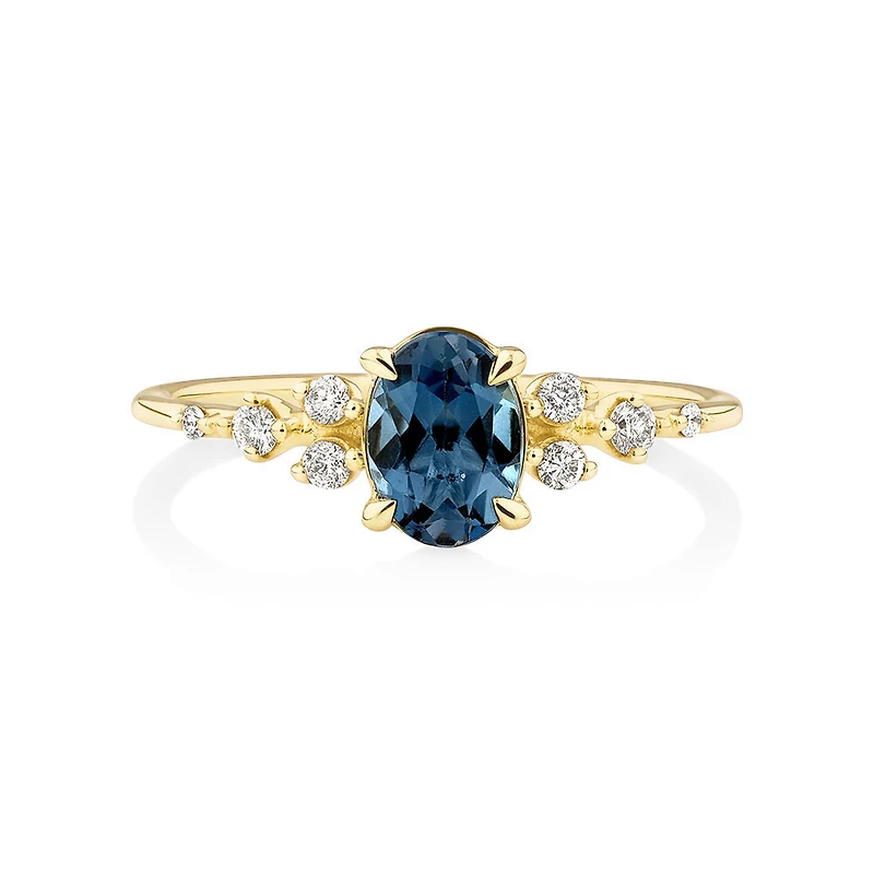 Ring with Blue Topaz and 0.12 Carat TW of Diamonds in 10kt Yellow Gold