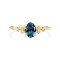 Ring with Blue Topaz and 0.12 Carat TW of Diamonds in 10kt Yellow Gold