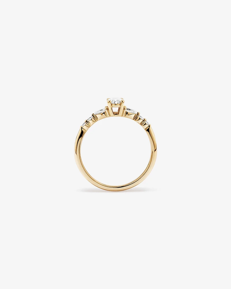0.59 Carat TW Oval and Pear Sidestone Engagement Ring in 14kt Yellow Gold
