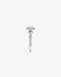 0.75 Carat TW Oval Cut Diamond Twist Side Accent Halo Engagement Ring in 14kt White Gold