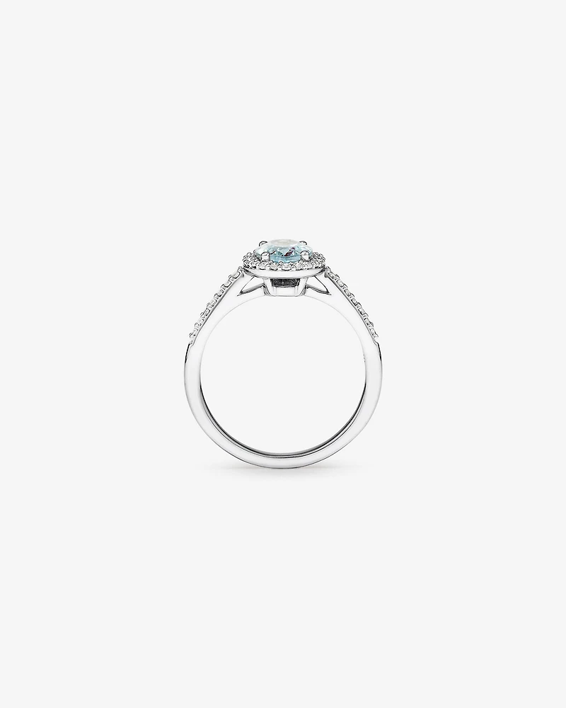 Oval Cut Blue Aquamarine Gemstone and 0.29 Carat TW Diamond Halo Ring in 10kt White Gold