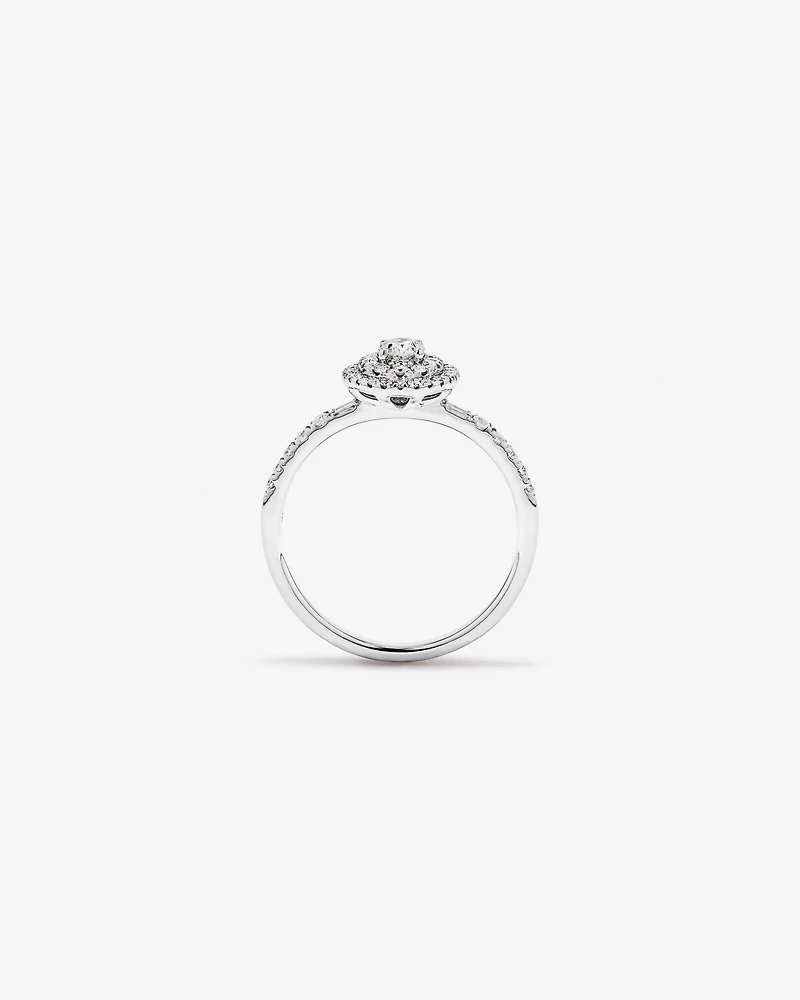 0.58 Carat TW Oval Diamond Halo Baguette Side Accent Engagement Ring in 14kt White Gold