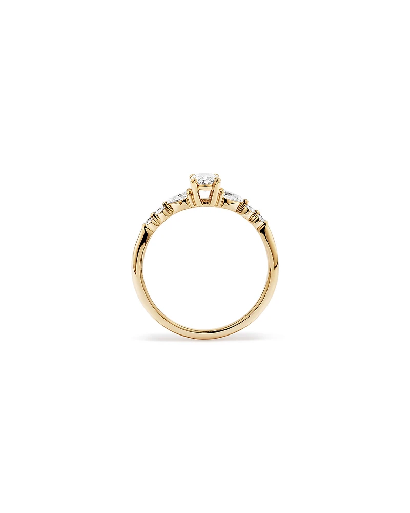 0.59 Carat TW Oval and Pear Sidestone Engagement Ring in 14kt Yellow Gold