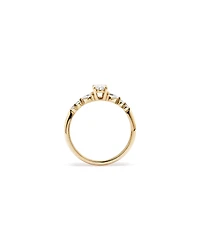 0.59 Carat TW Oval and Pear Sidestone Engagement Ring in 14kt Yellow Gold