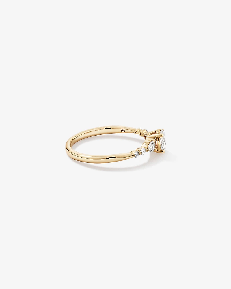 0.59 Carat TW Oval and Pear Sidestone Engagement Ring in 14kt Yellow Gold