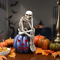 National Tree Company 11 in. LED Lit Skeleton on Purple Galaxy Pumpkin