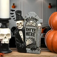 National Tree Company 12 in. Skeleton Holding Tombstone
