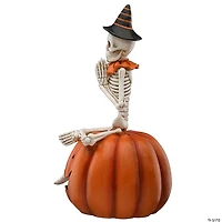 National Tree Company 12 in. Skeleton Sitting on Pumpkin