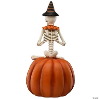 National Tree Company 12 in. Skeleton Sitting on Pumpkin