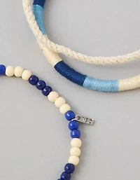 Emballage de trois bracelets tressés avec perles AE