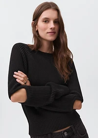 Knitted sweater with openings