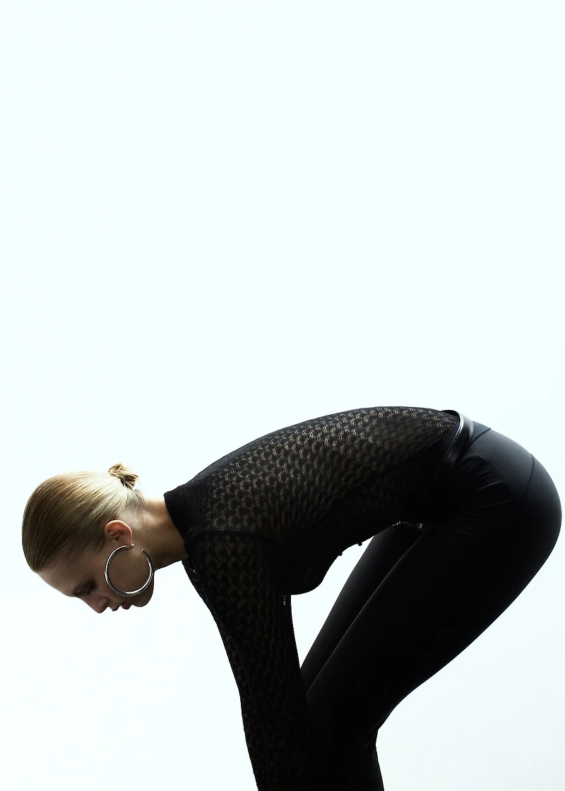 Openwork knitted sweater with bead fastening