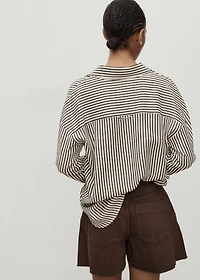 Denim shorts with frayed hem and pleats