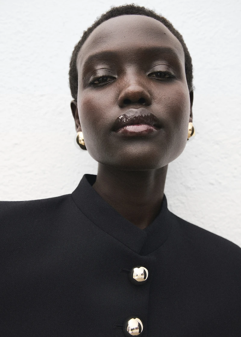 Jacket with jewel-button strip collar