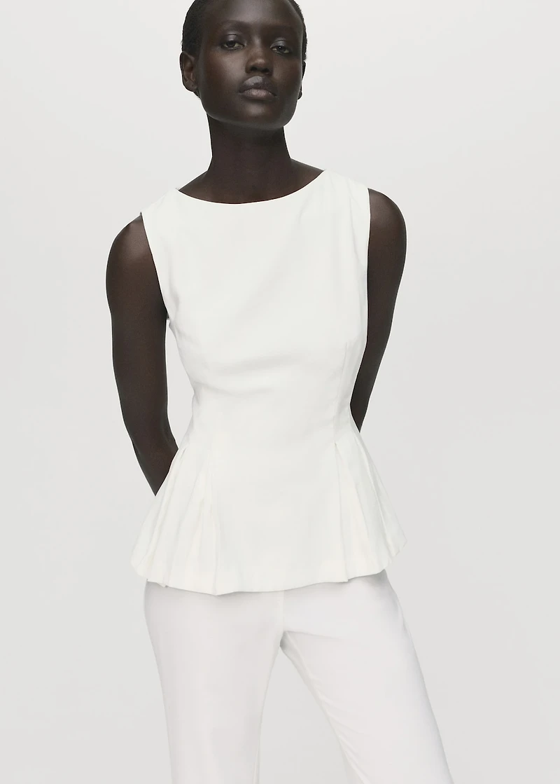 Peplum top with pleat detail