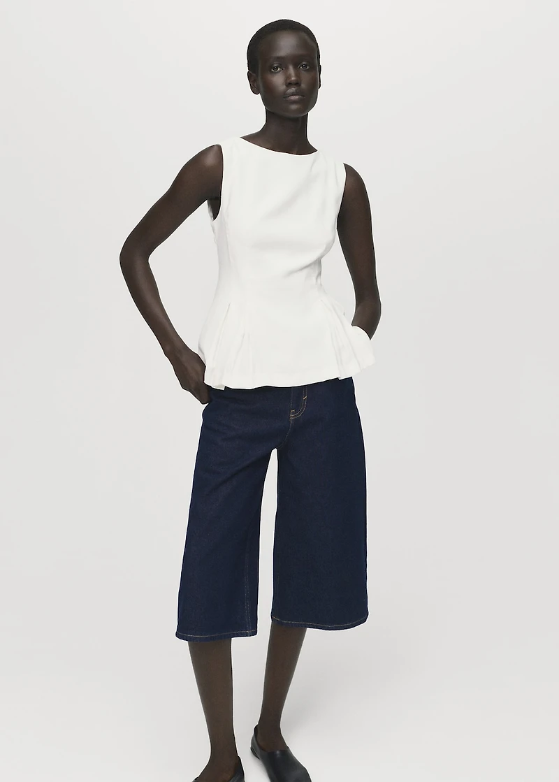 Peplum top with pleat detail