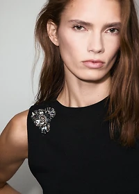 Knitted top with metallic flower