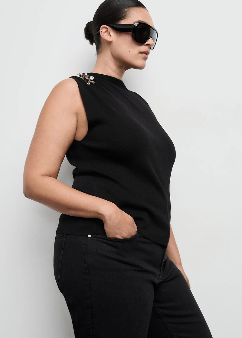 Knitted top with metallic flower